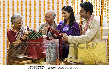 Family looking at diwali gifts View Large Photo Image Picture - Family looking at diwali gifts . Fotosearch