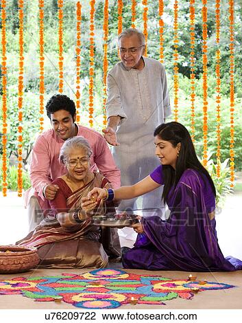 Family making a rangoli View Large Photo Image Stock Image - Family making a rangoli . Fotosearch