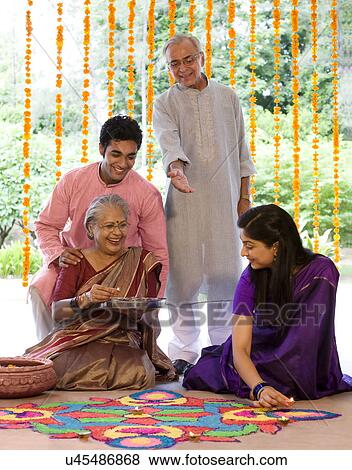 Family making a rangoli View Large Photo Image Stock Photo - Family making a rangoli . Fotosearch