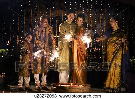 Stock Image - Family playing with firecrackers . Fotosearch