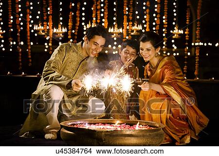 Family playing with fireworks View Large Photo Image Picture - Family playing with fireworks . Fotosearch
