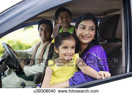Stock Image - Family sitting inside a car . Fotosearch
