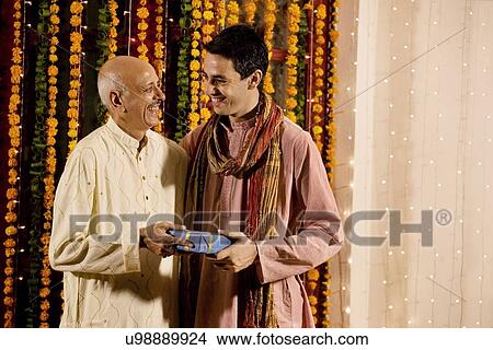 Picture - Father and son exchanging gifts . Fotosearch