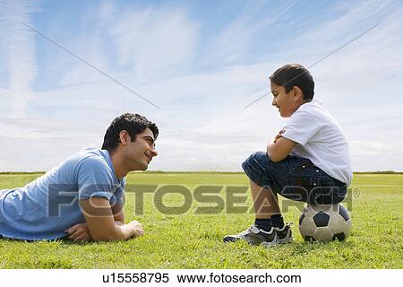 Father and son looking at each other View Large Photo Image Stock Photography - Father and son looking at each other . Fotosearch