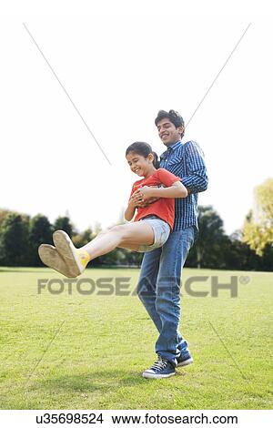 Father swinging his daughter around View Large Photo Image Picture - Father swinging his daughter around . Fotosearch