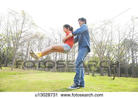 Father swinging his daughter around View Large Photo Image Stock Image - Father swinging his daughter around . Fotosearch