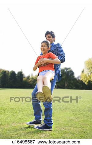 Stock Photo - Father swinging his daughter around . Fotosearch