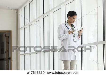 Stock Image - Female doctor with a digital tablet. Fotosearch