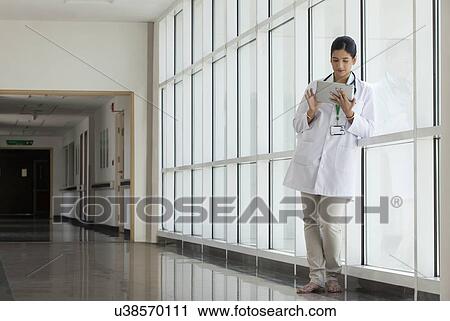Female doctor with a digital tablet View Large Photo Image Stock Image - Female doctor with a digital tablet. Fotosearch