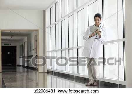 Female doctor with a digital tablet View Large Photo Image Stock Image - Female doctor with a digital tablet. Fotosearch