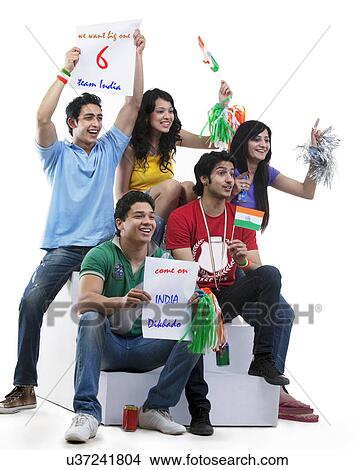 Friends cheering while watching a cricket match View Large Photo Image Picture - Friends cheering while watching a cricket match . Fotosearch