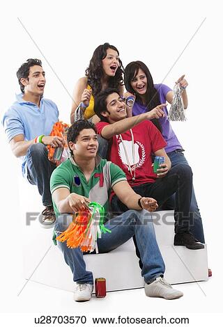 Stock Image - Friends cheering while watching a cricket match . Fotosearch