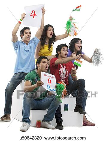 Friends cheering while watching a cricket match View Large Photo Image Stock Image - Friends cheering while watching a cricket match . Fotosearch