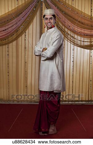 Full length of Indian groom smiling with arms crossed View Large Photo Image Picture - Full length of Indian groom smiling with arms crossed . Fotosearch