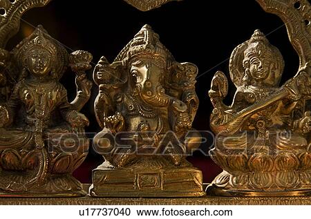 Stock Image - Ganesh, Lakshmi and Saraswati idol . Fotosearch