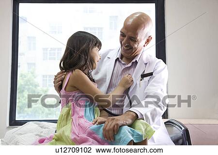 Girl checking a doctor's heartbeat View Large Photo Image Stock Image - Girl checking a doctor's heartbeat . Fotosearch