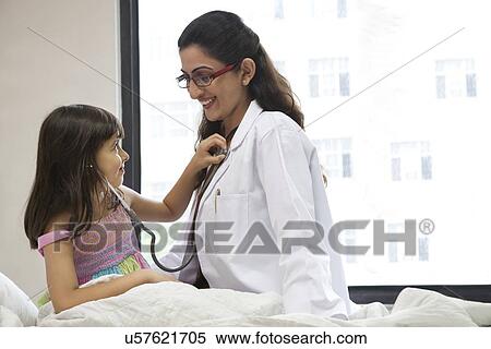 Girl checking a doctor's heartbeat View Large Photo Image Stock Photography - Girl checking a doctor's heartbeat . Fotosearch