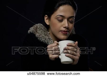 Stock Photo - Girl enjoying a mug of tea . Fotosearch