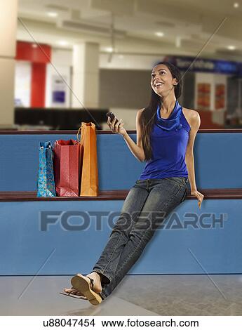 Girl holding a mobile phone View Large Photo Image Picture - Girl holding a mobile phone . Fotosearch