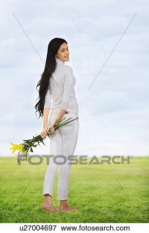 Girl holding flowers View Large Photo Image Stock Photo - Girl holding flowers . Fotosearch