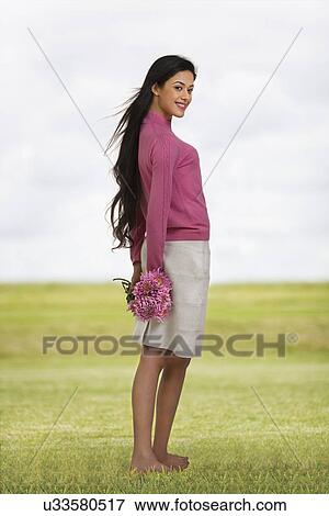 Girl holding flowers View Large Photo Image Stock Photo - Girl holding flowers . Fotosearch