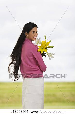Girl holding flowers View Large Photo Image Stock Photography - Girl holding flowers . Fotosearch