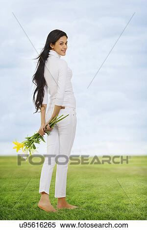 Girl holding flowers View Large Photo Image Stock Photography - Girl holding flowers . Fotosearch