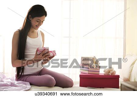 Girl holding gifts in her hand View Large Photo Image Stock Image - Girl holding gifts in her hand . Fotosearch