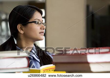Girl in a school library View Large Photo Image Stock Image - Girl in a school library . Fotosearch