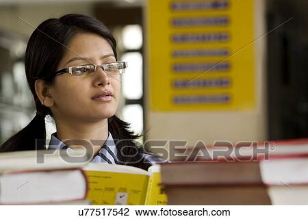 Girl in a school library View Large Photo Image Stock Image - Girl in a school library . Fotosearch