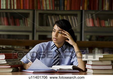 Girl in a school library View Large Photo Image Stock Photograph - Girl in a school library . Fotosearch