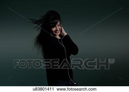 Girl listening to music View Large Photo Image Stock Image - Girl listening to music . Fotosearch