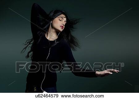 Girl listening to music View Large Photo Image Stock Photo - Girl listening to music . Fotosearch