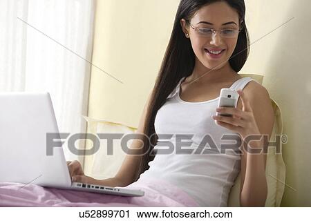 Girl looking at an sms View Large Photo Image Stock Image - Girl looking at an sms . Fotosearch