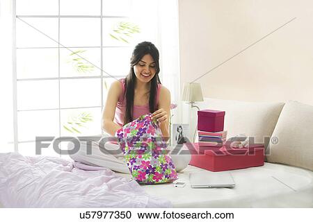 Girl looking into a plastic bag for gifts View Large Photo Image Stock Image - Girl looking into a plastic bag for gifts . Fotosearch