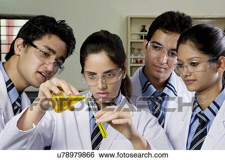 Girl pouring a liquid into a test tube View Large Photo Image Stock Photograph - Girl pouring a liquid into a test tube . Fotosearch