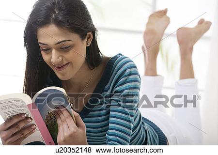 Girl reading a book in bed View Large Photo Image Stock Photo - Girl reading a book in bed . Fotosearch