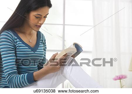 Stock Photo - Girl reading a book . Fotosearch