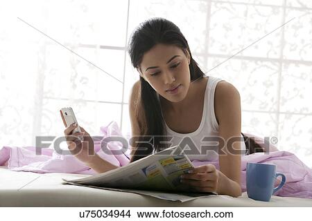 Girl reading a newspaper View Large Photo Image Picture - Girl reading a newspaper . Fotosearch