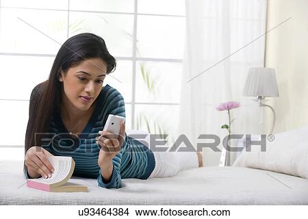 Picture - Girl reading an sms . Fotosearch