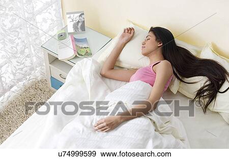 Girl sleeping in bed View Large Photo Image Stock Photo - Girl sleeping in bed . Fotosearch