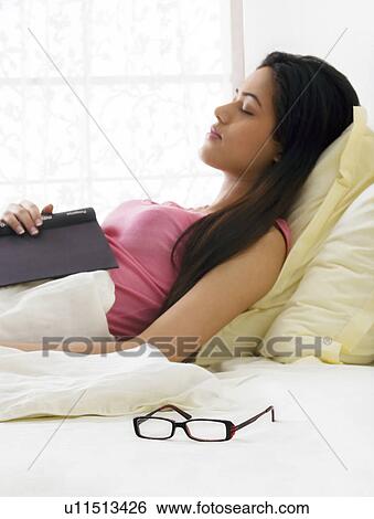 Girl taking a nap in bed View Large Photo Image Stock Photograph - Girl taking a nap in bed . Fotosearch