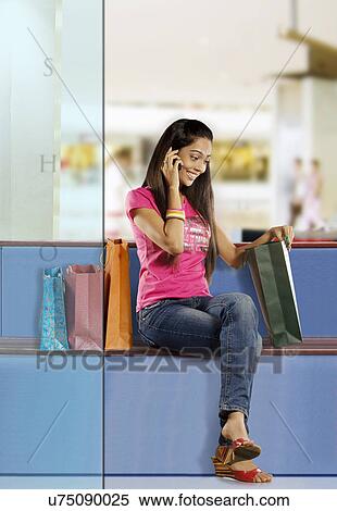 Girl talking on a mobile phone View Large Photo Image Stock Photography - Girl talking on a mobile phone . Fotosearch