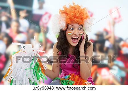 Stock Photo - Girl talking on a phone and cheering . Fotosearch