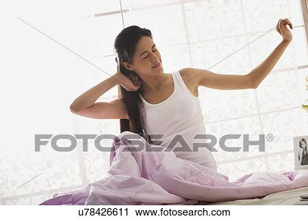 Stock Image - Girl waking up from deep sleep . Fotosearch