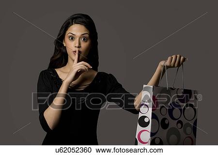 Girl with a gift bag giving a surprise View Large Photo Image Stock Image - Girl with a gift bag giving a surprise . Fotosearch