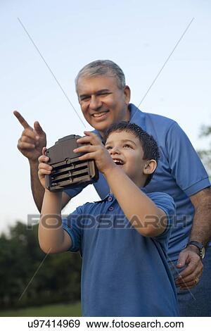 Grandfather and Boy Playing with Radio Controlled Handset View Large Photo Image Stock Photo - Grandfather and Boy Playing with Radio Controlled Handset. Fotosearch