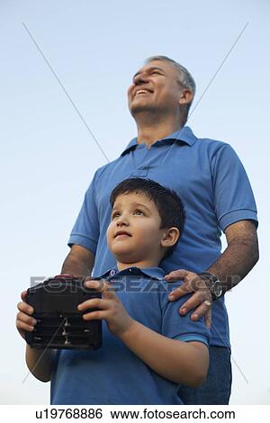 Grandfather and Boy Playing with Radio Controlled Handset, View Large Photo Image Stock Photograph - Grandfather and Boy Playing with Radio Controlled Handset,. Fotosearch
