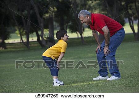 Stock Photo - Grandfather and grandson enjoying in a park. Fotosearch