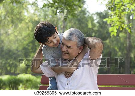 Grandfather and grandson enjoying in a park View Large Photo Image Stock Photography - Grandfather and grandson enjoying in a park. Fotosearch